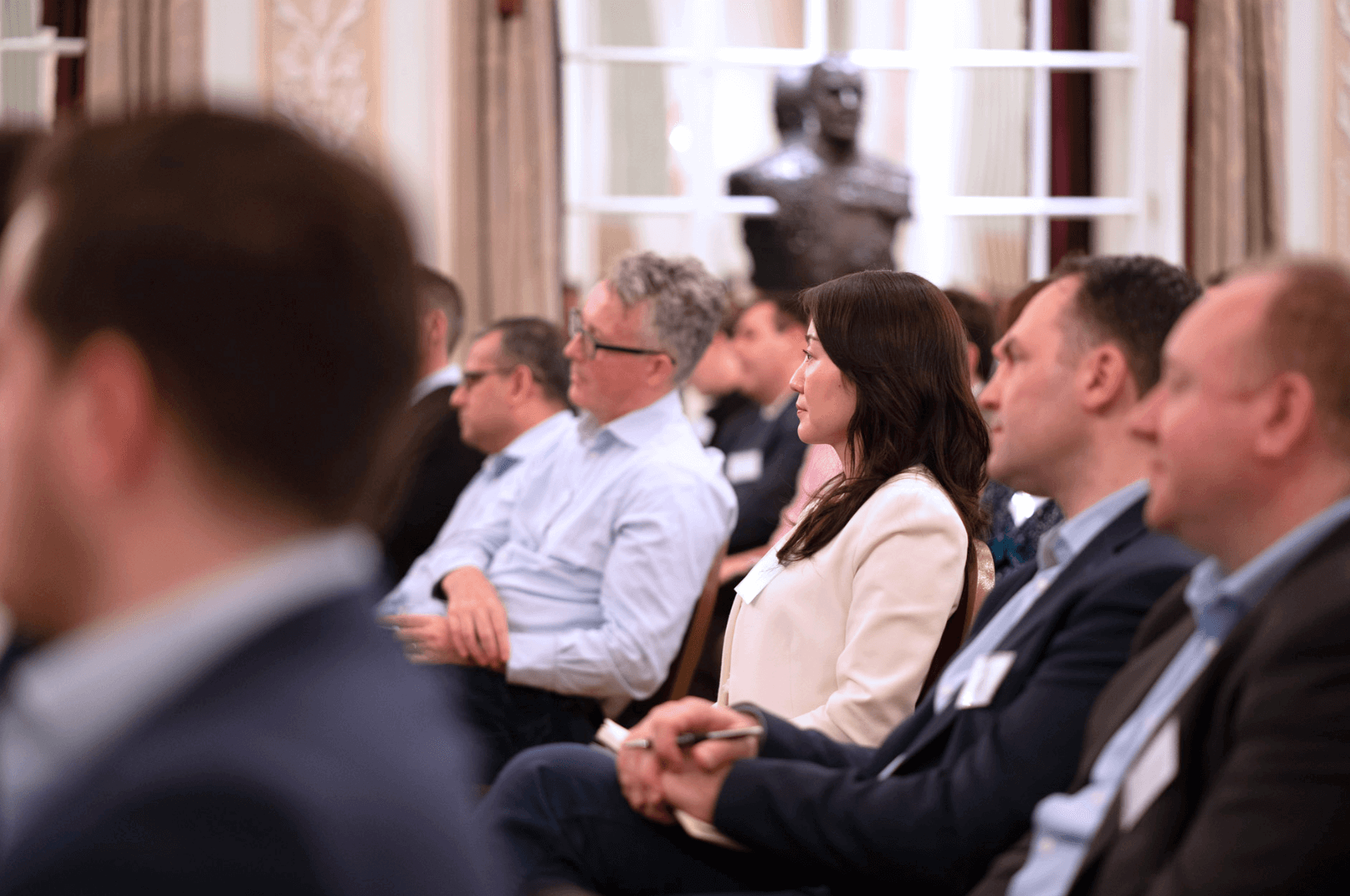 landscape focussed on a woman sat in an event audience