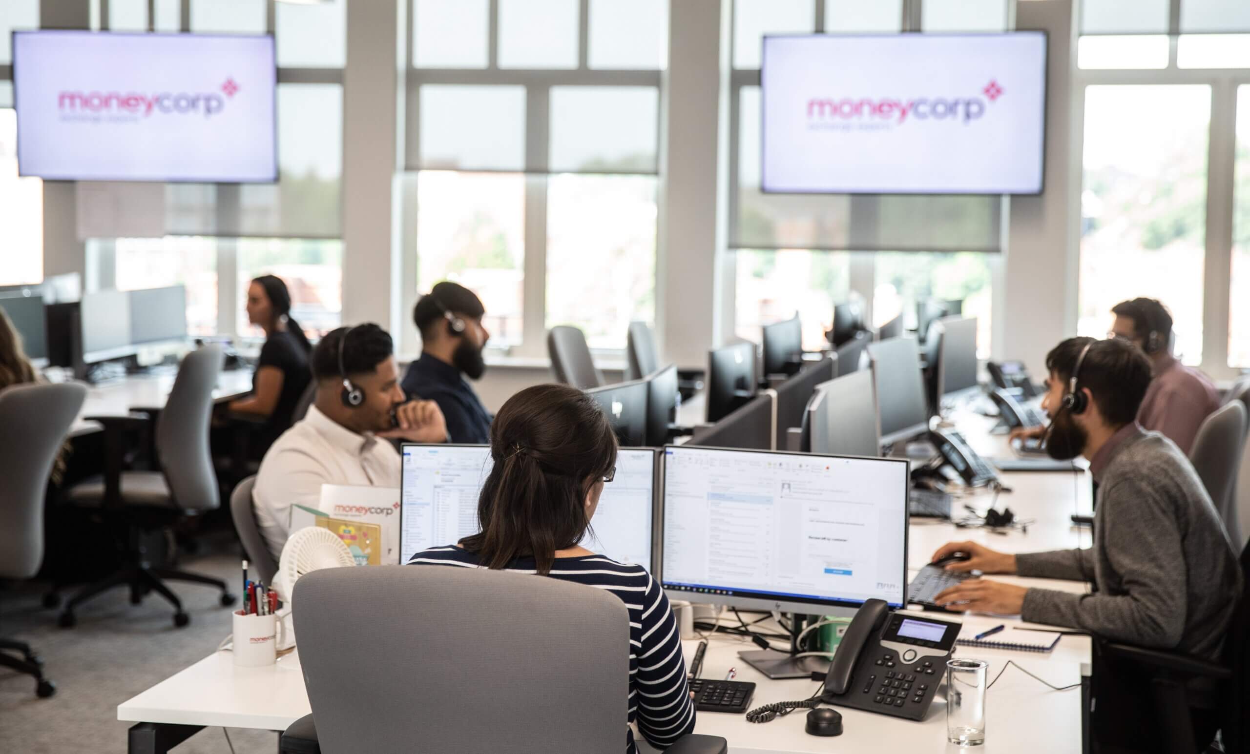 Software developer working in a busy office